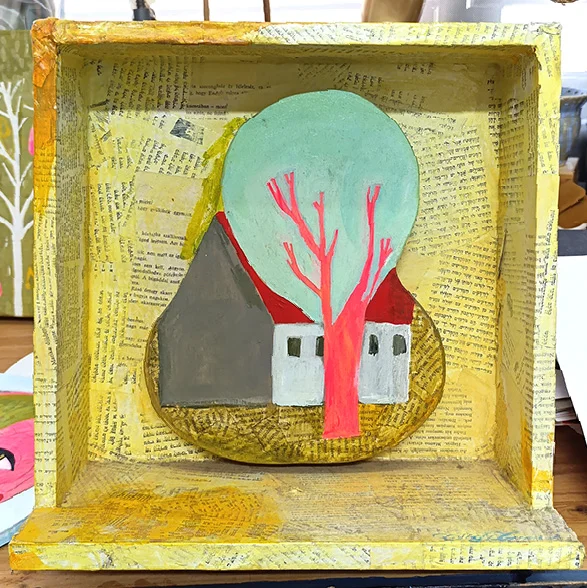 A house and a pink tree